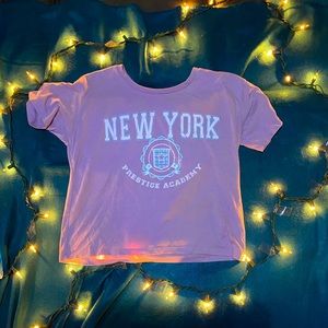 pastel purple crop top that says “NEW YORK prestige academy”